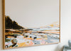 Framed abstract landscape painting featuring rocky terrain, a body of water, and a forested area in warm and muted tones.