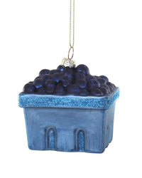 Handcrafted by Cody Foster, the Farmstead Blueberries Ornament features a blue berry basket filled with glittery blueberries and includes a gold hanging string, perfect for adding festive charm to your Christmas tree.