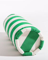 The Business & Pleasure Co Bolster Pillow - Crew Canyon Green Stripe, featuring green and white horizontal stripes and spill, stain, and fade resistance, is shown lying on its side against a plain white background.