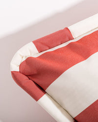 Close-up of the Euro Throw Pillow - Crew Le Sirenuse Stripe by Business & Pleasure Co, showing its red and white wide stripes, spill-resistant soft fabric, and rounded edges—ideal for indoor or outdoor use.