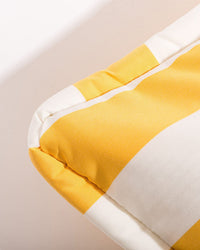 Close-up of the Euro Throw Pillow - Crew Mimosa Yellow Stripe by Business & Pleasure Co, featuring yellow and white stripes with detailed stitching. Ideal for outdoor use, its spill and stain resistant for easy care.