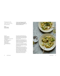A cookbook spread from Chronicle Books’ "A Meal For Two" features crispy gnocchi with corn, ricotta, and spinach—served on two plates with forks and white wine on a marble table—perfect for easy weekday dinners.