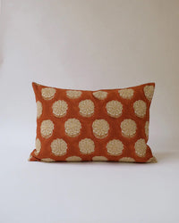 The Alisha Linen Pillow by Soil to Studio (14 x 20 in, Rust) features a hand-block-printed cream floral pattern on orange linen with a plain light background, from the Thar Edit collection.