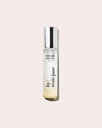 A clear glass bottle of Rosie Jane Perfume Oil in Matilda with a silver cap, set against a light beige background—an irresistible passionfruit scent perfect for daily wear.