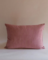 The Zeenat Linen Pillow - 14 x 20 by Soil to Studio, featuring vertical pink and beige stripes, is displayed against a plain light background.