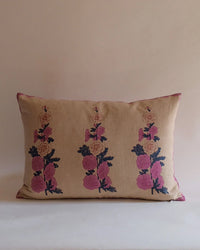 The Zeenat Linen Pillow (14 x 20) by Soil to Studio features a rectangular beige cover with three vertical rows of pink and dark purple florals inspired by the Valley of Flowers, displayed against a plain light background.