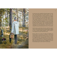 A person in a light coat and hat walks with a wicker basket through a sunlit autumn forest as "Four Seasons of Cabin Cooking" by Cozy Publishing displays seasonal recipes on the right. Moss carpets the ground beneath tall surrounding trees.