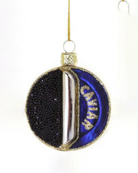 The Cody Foster Caviar Tin Ornament is a hand-crafted glass decoration featuring "CAVIAR" in gold on a blue backdrop with lifelike black beads, elegantly finished with a gold hanging string.