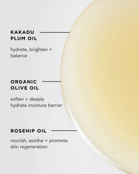 A close-up of Rosie Jane's Wake Body + Bath Oil, a translucent yellow liquid with kakadu plum (hydrates, brightens), organic olive (softens), and rosehip—ideal as a nourishing body or hydrating bath oil for glowing skin.
