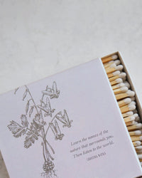 Hudson Valley Matches | Bleeding Hearts by The Floral Society: A hand-illustrated matchbox with white-tipped matches, wildflowers, and the quote “Learn the names of the nature that surrounds you. Then listen to the world.” Perfect for nature lovers.