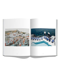 An open book, "Italian Summer" by Simon & Schuster, showcases two Natalie Obradovich photos: a vibrant Italian beach town with chairs and umbrellas, and a serene poolside with blue loungers by the ocean—capturing Italy’s coastal charm.