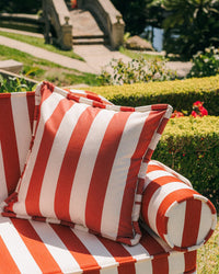 The Euro Throw Pillow - Crew Le Sirenuse Stripe by Business & Pleasure Co adds style to your garden or patio with red and white stripes. Spill- and stain-resistant, its ideal for indoor or outdoor relaxation amid nature’s beauty.