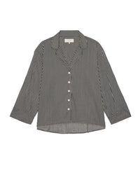 The Pajama Shirt in Black & Cream Crew Stripe by the Great. Sleep features black and cream vertical stripes, a button-down front, collar, and long sleeves, shown on a white background.