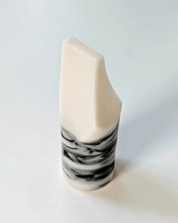 The Erode Soap Mini in Jasmine Ylang Ylang by Ume Studio features a white geometric form with marbled black and gray accents at the base, photographed against a plain white background for a clean, elegant look.