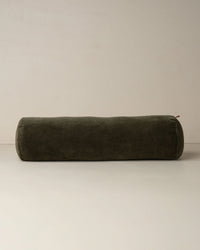 The Saarde Velvet Structured Bolster in Dark Olive is displayed on a plain light surface with a neutral backdrop.