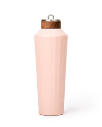 The 25oz Hemingway Flask in Dusty Pink by Business & Pleasure Co features a faceted design, vacuum insulation, and a wooden-accented metal lid, shown upright against a white background.