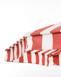A close-up of the Amalfi Umbrella - Crew Le Sirenuse Stripe by Business & Pleasure Co, featuring a red and white striped, UV-resistant canopy against a plain white background.