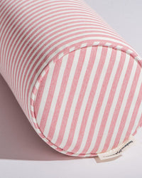 The Bolster Pillow - Laurens Pink Stripe by Business & Pleasure Co features pink and white stripes, stain and fade resistant fabric, and is perfect for indoor or outdoor use.