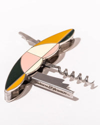 The Picnic Set - Laurens Pink Stripe by Business & Pleasure Co features a multicolored corkscrew and bottle opener with a geometric enamel design, perfect for premium picnic experiences, shown on a white background.