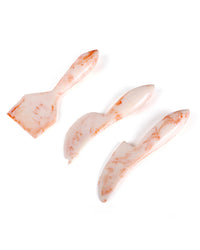 The Casa Amarosa Resin Cheese Knife Set of 3 in Ivory Pink features a spatula, spreader, and knife with a marble pattern, stylishly arranged on a white background.