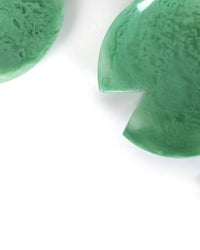The Casa Amarosa Resin Salad Server Set in Green features two lily pad-shaped servers crafted from smooth, slightly translucent resin, shown against a white background.