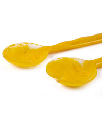 The Casa Amarosa Resin Salad Server Set in Mustard includes one solid and one slotted spoon, shown on a white background.