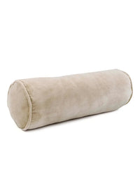 The Casa Amarosa Velvet Bolster Pillow in Biscotti features a soft cotton velvet cover and plush cylindrical design, adding a stylish decorative accent against a plain white background.