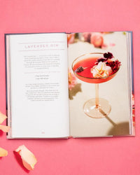 Floral Libations by Chronicle Books showcases a lavender gin recipe and an edible flower cocktail in a coupe glass, set against a pink background with petals—ideal inspiration for floral drinks.