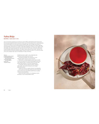 A bowl of red salsa on a white plate beside dried red chilies, with a recipe from Andrea Pons’ Mamacita cookbook by Chronicle Books printed on the left.