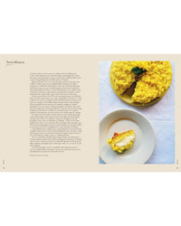 A yellow Torta Mimosa cake sits on a plate with a slice cut out. Inspired by Wild Figs and Fennel from Chronicle Books, the slice rests on a smaller plate with a fork, as Italian recipe text appears to the left.