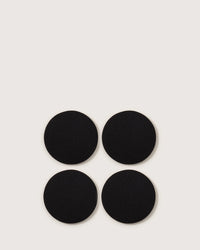 Four black Bierfilzl Merino Wool Felt Round Coasters by graf lantz, crafted from premium German merino wool, come in a set of 4—ideal for sustainable and stylish home décor.