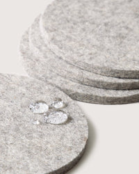 Close-up of graf lantz Bierfilzl Merino Wool Felt Round Coaster Solid in Granite (4 Pack), showing water droplets beading on the German Merino wool surface.