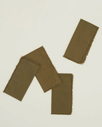 The Hawkins New York Essential Dinner Napkins in Olive, set of 4, feature frayed edges and add style to any table setting—perfect cotton napkins for everyday or special occasions.
