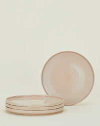 Set of 4 Essential Dinner Plates in Blush by Hawkins New York—three stacked, one behind showing the elegant stoneware’s subtle circular pattern. These dishwasher-safe plates brighten any table.