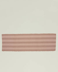 The Essential Floor Runner in Blush by Hawkins New York, featuring pale pink and beige stripes and crafted from recycled fibers, is displayed flat on a light, neutral background.