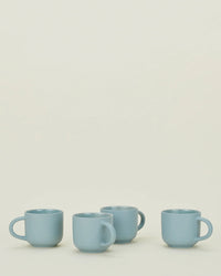 A set of four Hawkins New York Essential Mugs in Sky is arranged in a row on a plain, light surface with a neutral background.