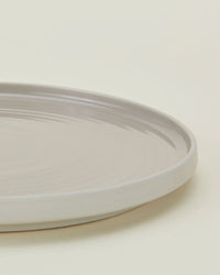 A close-up of Hawkins New Yorks Essential Salad Plates in Light Grey—a set of 4 stoneware plates—shown on a neutral background.