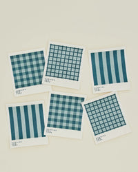 The Essential Swedish Dishcloths in Sky/Peacock by Hawkins New York come as a set of six with blue plaid and striped patterns, adding an eco-friendly touch to your kitchen essentials.