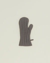 The Hawkins New York Simple Linen Oven Mitt in Dark Grey is shown on a plain light background, featuring quilted linen, heat-resistant padding, a thumb section, and a small hanging loop.