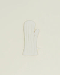 A single Hawkins New York Simple Linen Oven Mitt in Ivory, featuring heat-resistant padding, is shown on a plain, light-colored background.