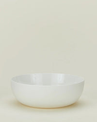 The Hawkins New York Simple Porcelain Serving Bowl, with smooth, clean lines, sits empty on a light, neutral background.