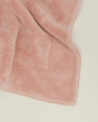 The Hawkins New York Simple Terry Bath Mat in Blush, featuring a soft, textured cotton surface and rectangular shape, is displayed on a white background.