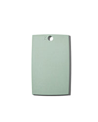 The (mini) reBoard® | Moss by Material is a rectangular, light green cutting board made from sustainable materials with a hole near the top center, shown on a white background.