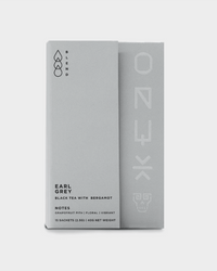 A minimalist gray box of Onyx Coffee Lab Earl Grey Tea | 15 Sachets features bergamot oil and taste notes of grapefruit pith, floral, and vibrant.
