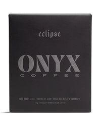 A black bag of Onyx Coffee Lab’s Eclipse Coffee, labeled as a dark roast with tasting notes and 10oz of specialty whole bean coffee.