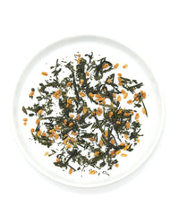 Onyx Coffee Lab’s Genmaicha Tea | 15 Sachets—a Kyoto classic blend of Sencha green tea and toasted brown rice—is displayed on a white plate, viewed from above.