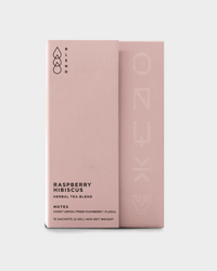 A minimalist pink box of Onyx Coffee Lab’s Raspberry Hibiscus Tea | 15 Sachets highlights this caffeine free, antioxidant-rich herbal blend and its flavor notes on the front.