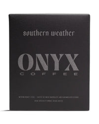 A 10oz black box of Onyx Coffee Lab’s Southern Weather Coffee features silver text with details on its medium roast and specialty flavor notes.
