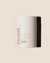 A white PAUME container of the Overnight Hand & Foot Hydration Mask is photographed against a beige background, with a shadow on the right side.