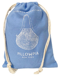 The French Market Bag No.2 in French Blue by PILLOWPIA is an organic cotton bag with white drawstring ropes, printed text The French Market Bag, PILLOWPIA New York, and a vintage net bag line drawing on the front.
